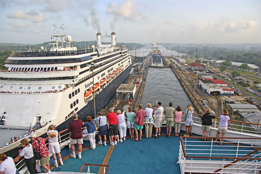 Passengers on a ship&rsquo;s bow watching a Panama Canal transit