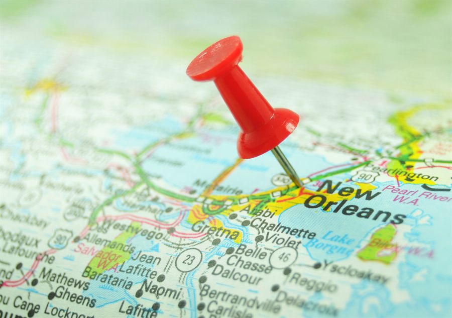 Red pin marking a city on a road map